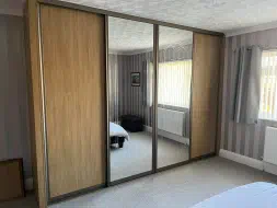 Lancaster oak and mirror sliding doors in light bronze frames, fitted in Ingleby Barwick